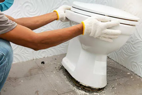 Plumber fixing toilet